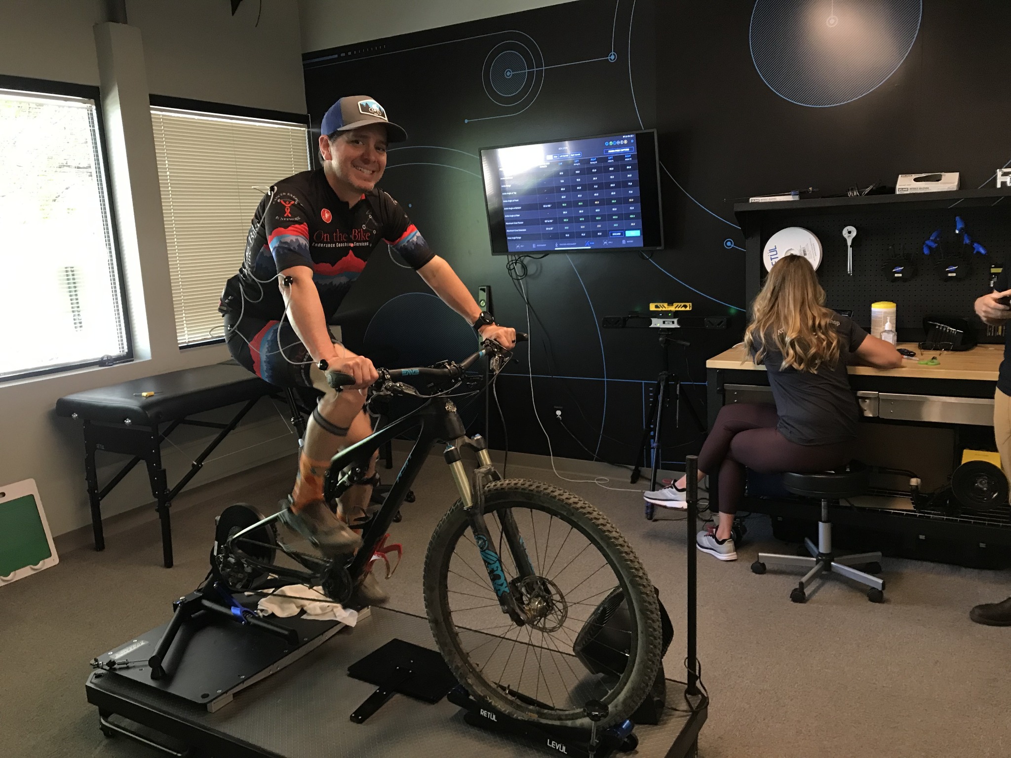 Cyclist undergoing a Retül bike fit with motion capture markers.